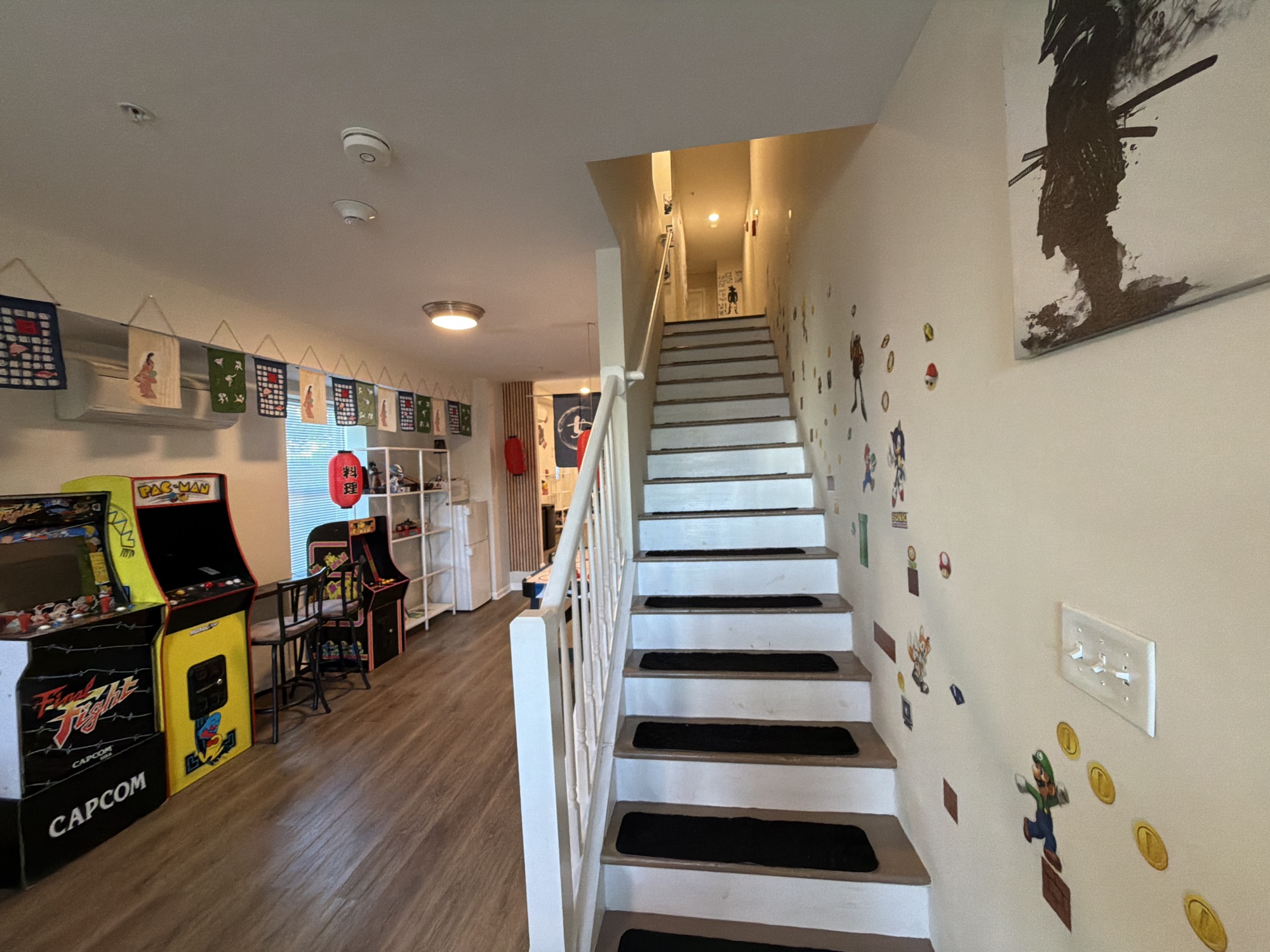 Arcade cabinets and the Mario staircase in the Edo play room