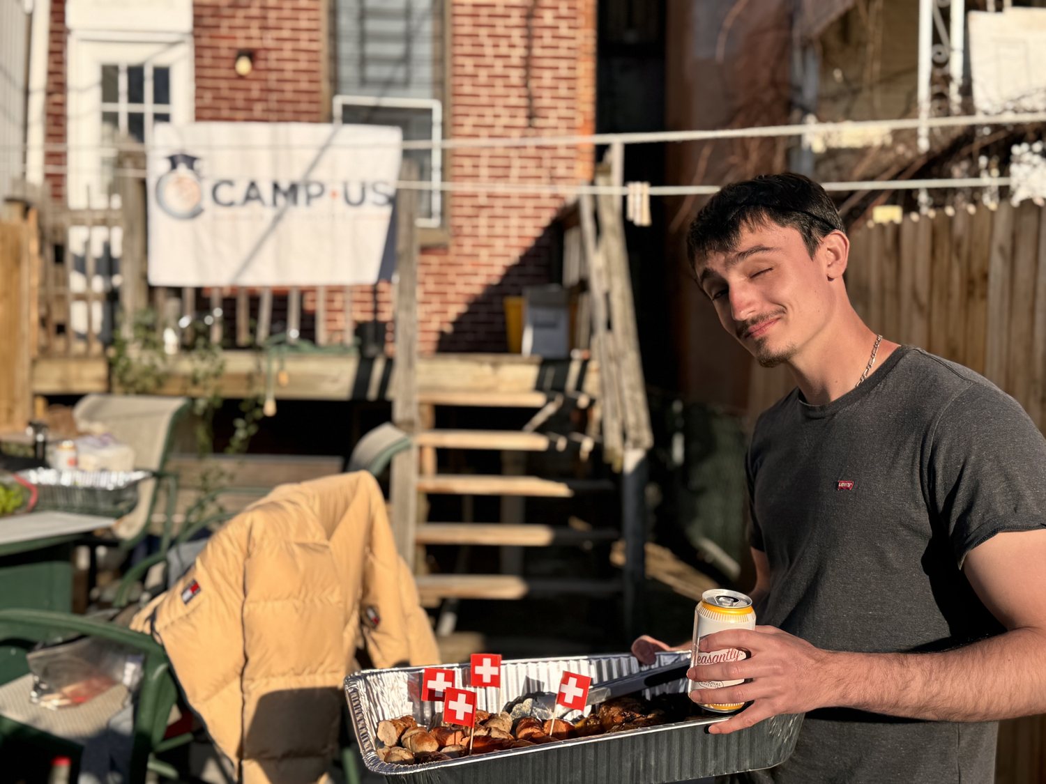 A resident bringing food to the table at a CAMP-US cookout