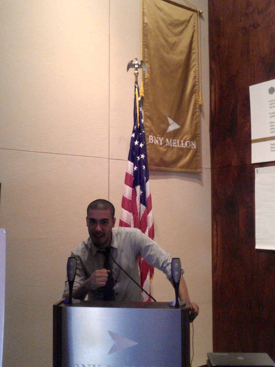 Nassim Azzi speaking at a podium during his years in finance